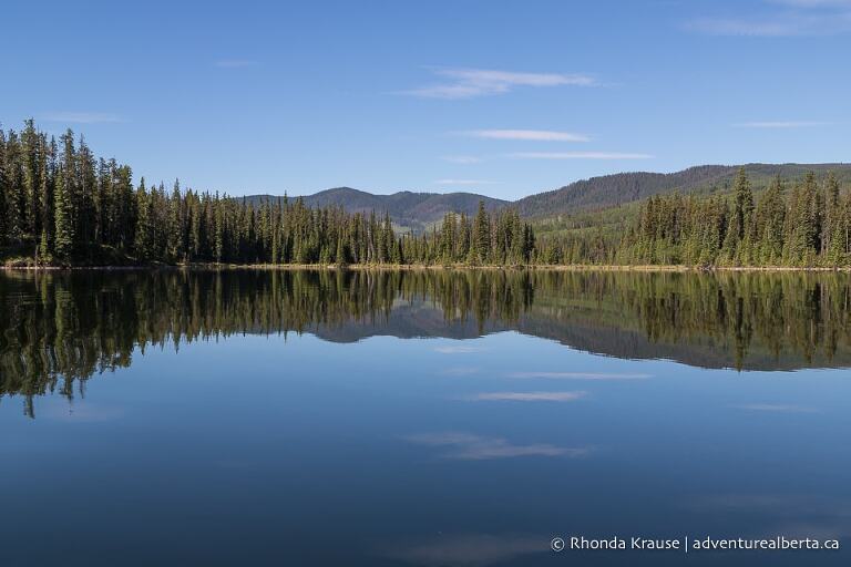 Jarvis Lake reflecting the surrounding foothills.